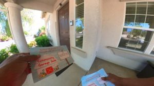 Real Estate Garage sale flyer being distributed door-to-door, announcing a neighborhood event and attracting potential buyers with enticing item descriptions and details